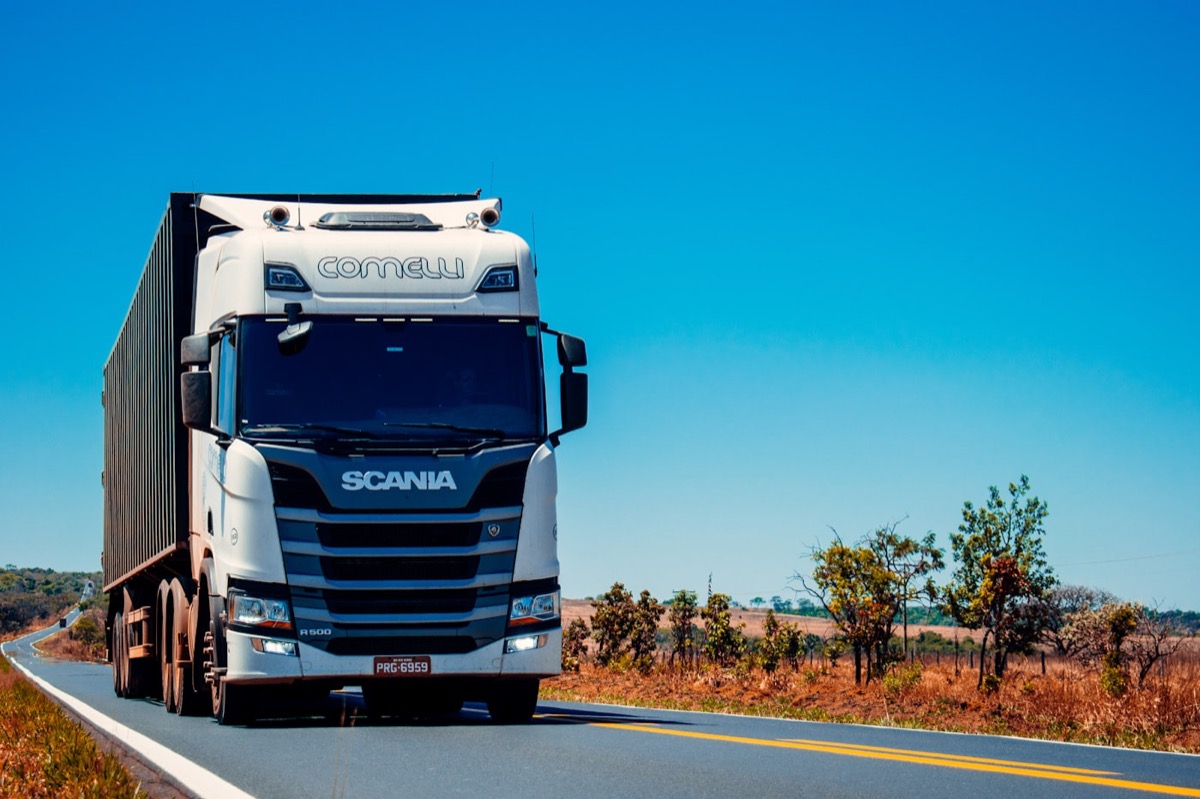Freight truck hauling a container on a cross-border African highway — road freight from Johannesburg across SADC