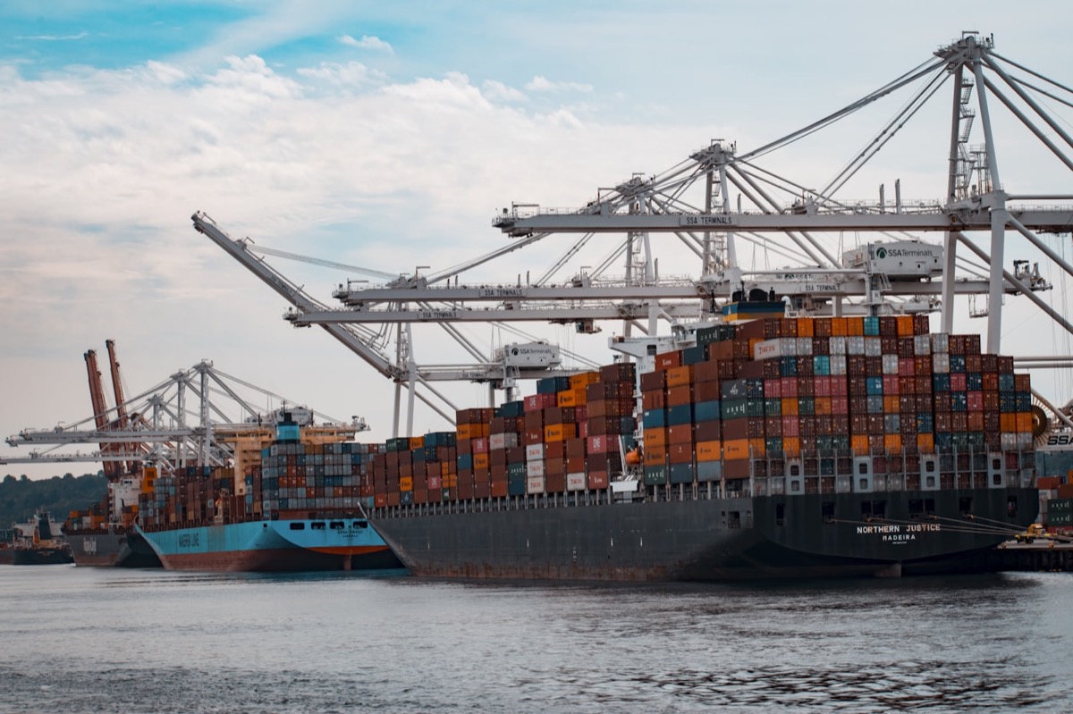 Container ships loading under quay cranes — sea freight forwarding via Durban and Cape Town ports